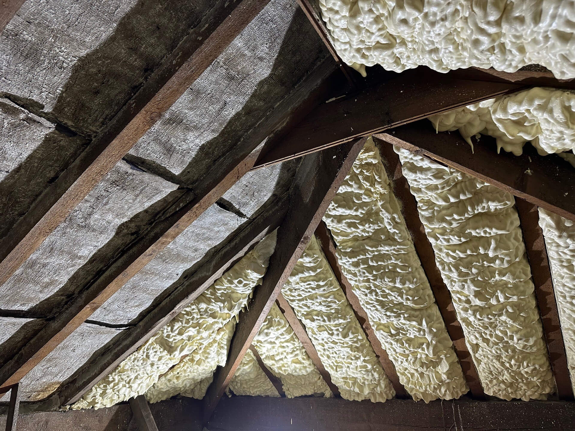 Loft roof covered with spray foam before removal